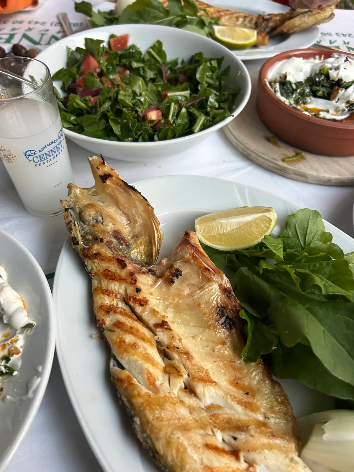 Taze ızgara balık, roka ve limon eşliğinde